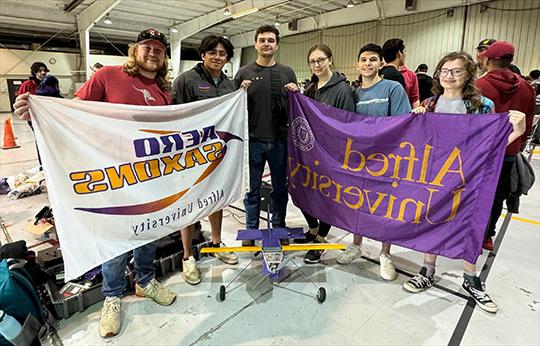 group of students holding two banners