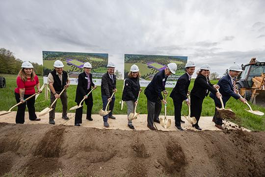 group of people shoveling dirt